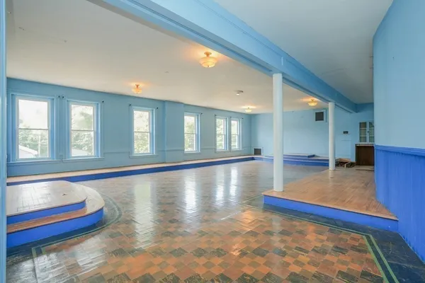 a view of room with window and wooden floor