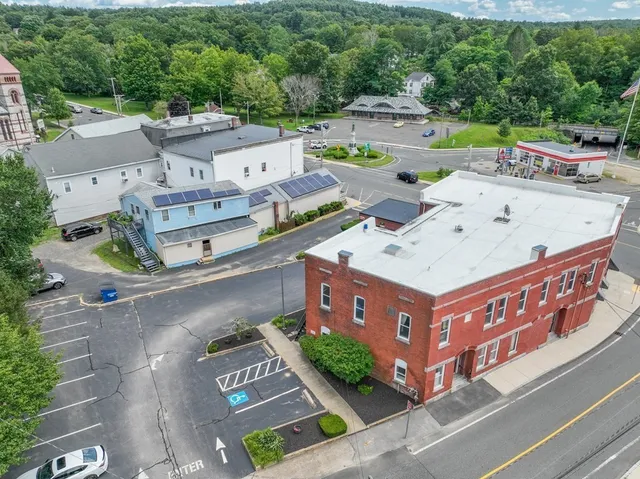 an aerial view of a house with outdoor space and parking