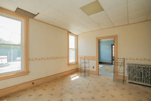 a view of an empty room with a window and closet