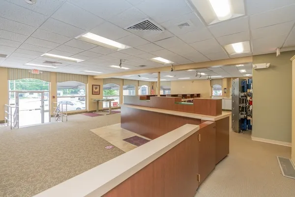 a very nice looking room with a large window and furniture