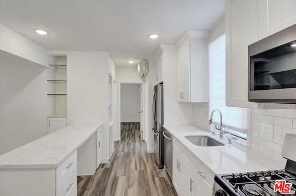 a kitchen with a sink stove and refrigerator