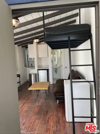 a hallway with a chair and wooden floor