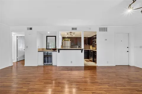 a bathroom with a granite countertop sink and a large mirror