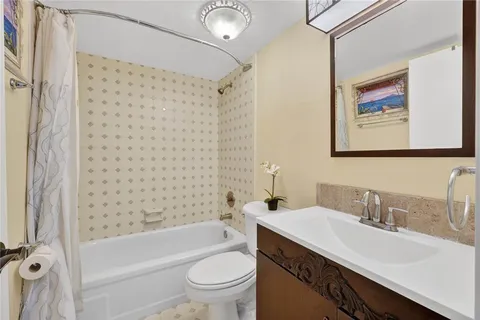 a view of a room with wooden floor and a ceiling fan