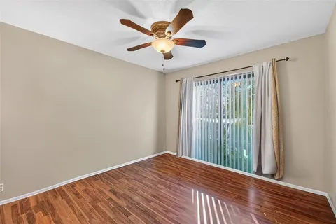 a view of a kitchen with wooden floor and electronic appliances