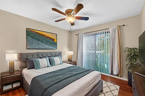 a view of a building with a big yard and large trees