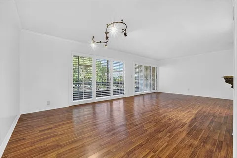 a living room with furniture rug and wooden floor