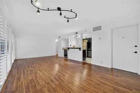 a kitchen with a appliances a sink and a refrigerator