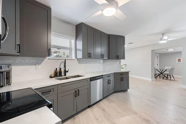 a kitchen with a sink stove and cabinets