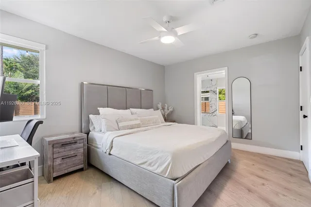 a bedroom with a bed a couch and a large window