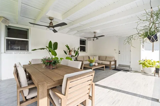a dining room with furniture and a potted plant