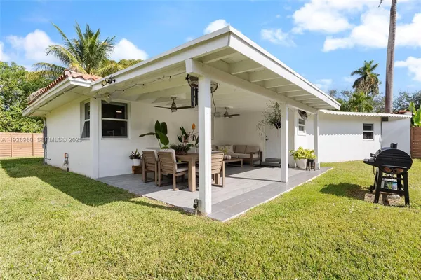 a view of a house with backyard porch and sitting area