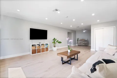 a living room with furniture and a potted plant