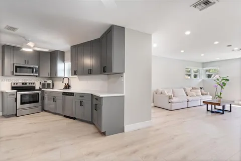 a kitchen with cabinets stainless steel appliances and a sink