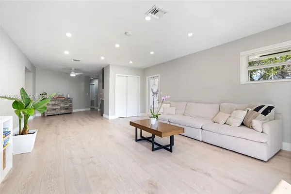 a living room with furniture and a potted plant