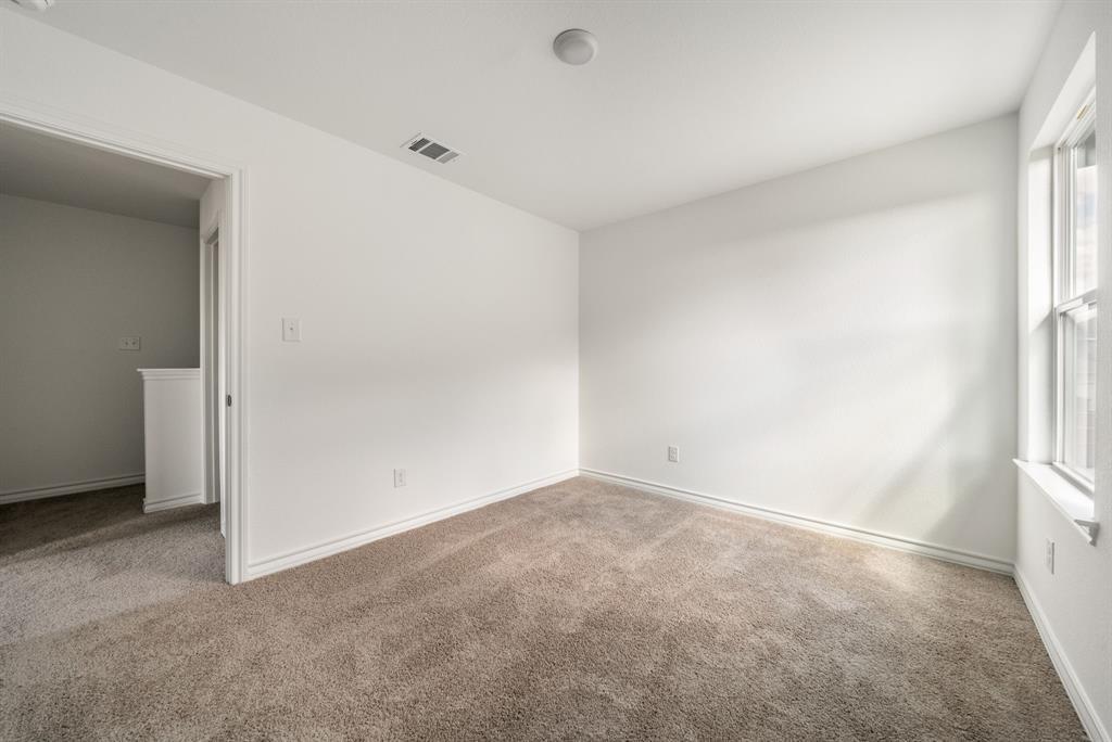 123 Watkinville Road Hutto, TX 78634 - Photo 17 of 30 Unfurnished room with light colored carpet and baseboards