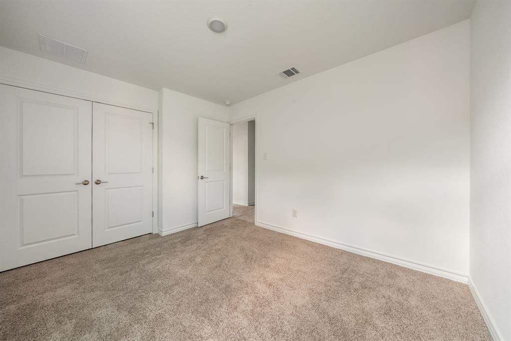 123 Watkinville Road Hutto, TX 78634 - Photo 19 of 30 Unfurnished bedroom with a closet and carpet floors