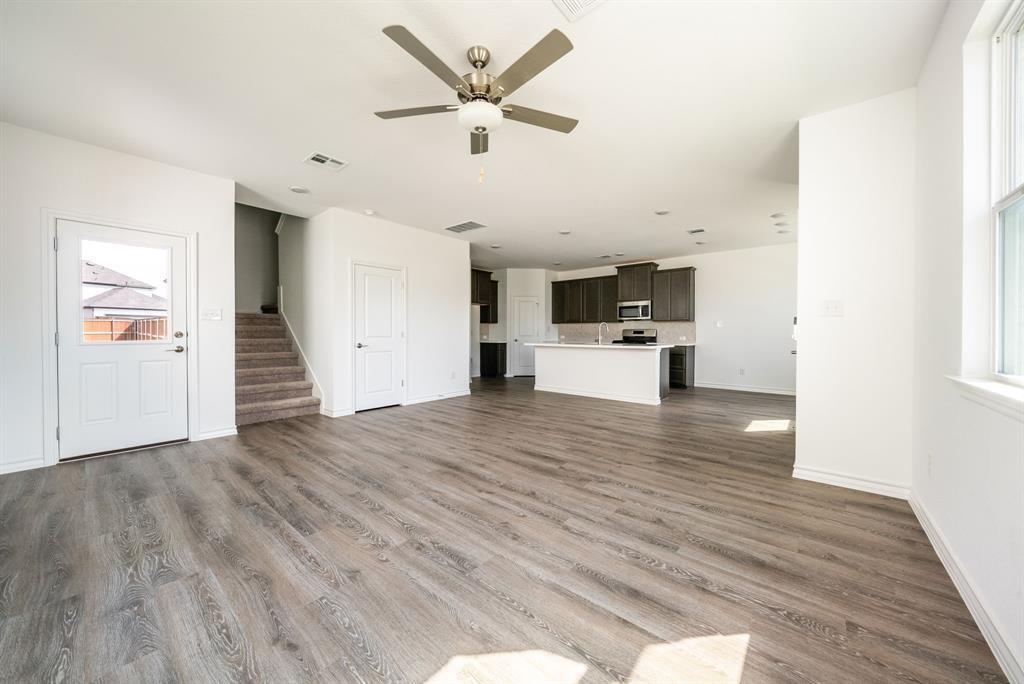123 Watkinville Road Hutto, TX 78634 - Photo 5 of 30 Unfurnished living room with ceiling fan and dark wood-style flooring
