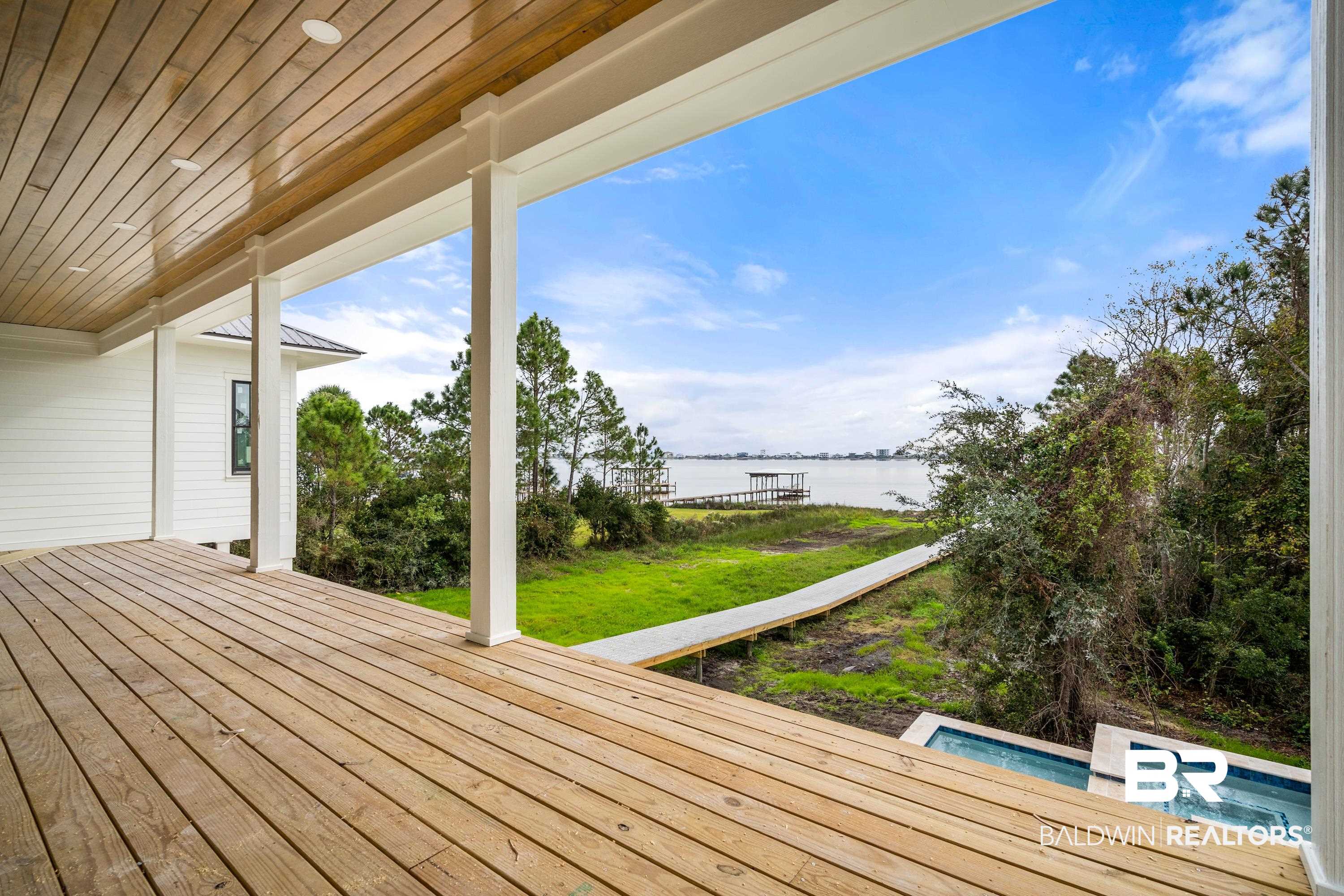 14686 State Highway Gulf Shores, AL 36542 - Photo 11 of 44 Wooden deck with a yard and a water view
