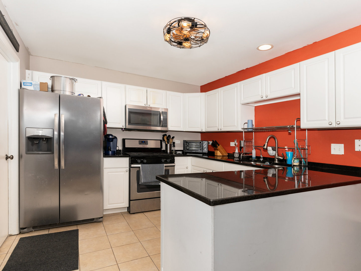 1416 Trailside Drive Beecher, IL 60401 - Photo 6 of 24 a kitchen with stainless steel appliances granite countertop a refrigerator a stove and a sink with wooden floor