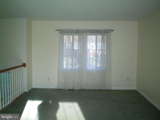613 Truxton Road Annapolis, MD 21409 - Photo 1 of 24 an empty room with wooden floor and windows