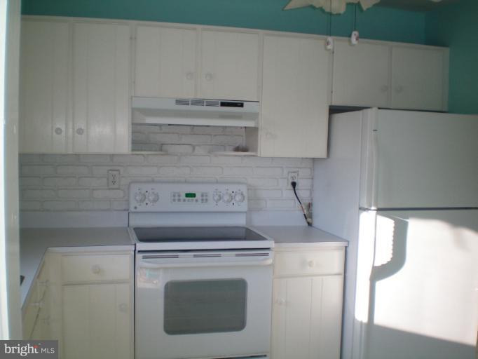 613 Truxton Road Annapolis, MD 21409 - Photo 6 of 24 a close view of a stove top oven a sink and cabinets