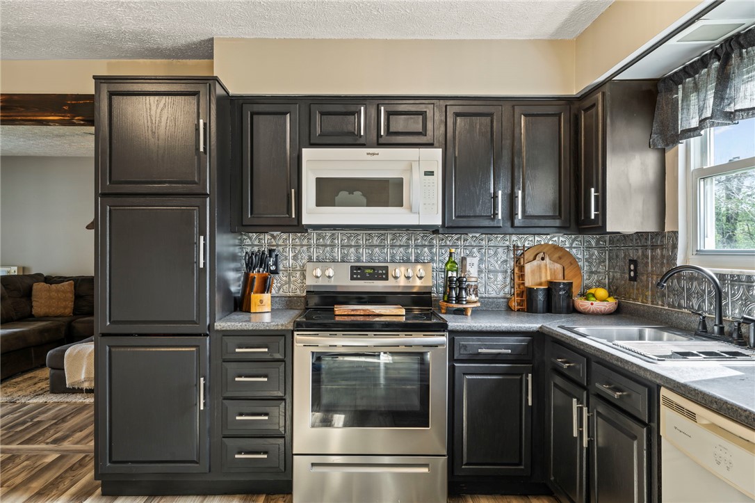 8969 Franklin-Trenton Road Franklin, OH 45005 - Photo 32 of 49 This functional kitchen features dark cabinetry and stainless steel appliances, perfect for everyday living.