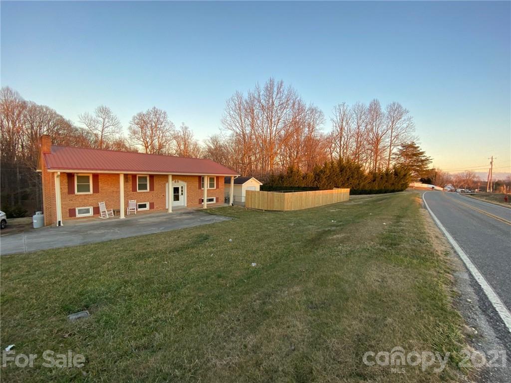 4903 Horseshoe Bend Road Hudson, NC 28638 - Photo 1 of 26 a front view of a house with a garden and trees