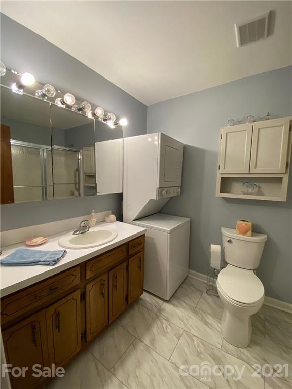 4903 Horseshoe Bend Road Hudson, NC 28638 - Photo 13 of 26 a bathroom with a granite countertop sink mirror vanity and toilet