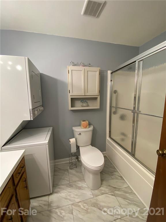 4903 Horseshoe Bend Road Hudson, NC 28638 - Photo 14 of 26 a bathroom with a sink toilet and shower