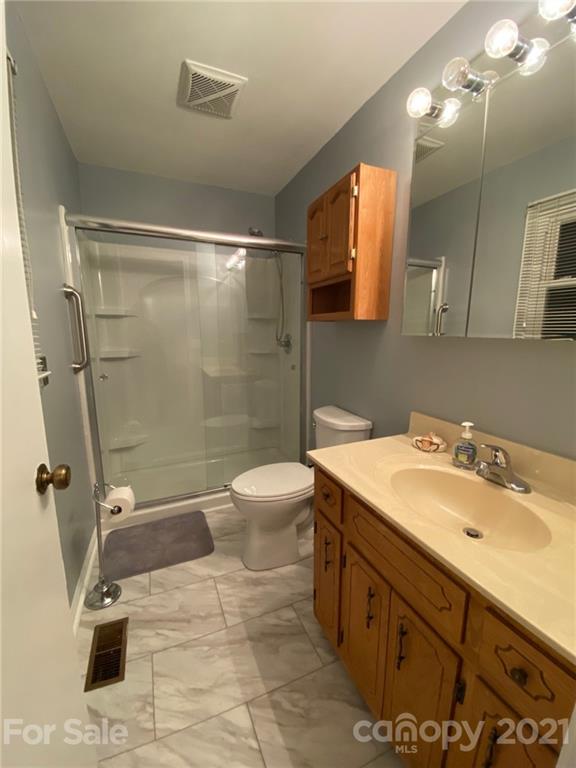 4903 Horseshoe Bend Road Hudson, NC 28638 - Photo 18 of 26 a bathroom with a sink a toilet and shower