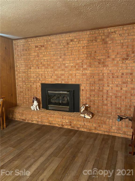 4903 Horseshoe Bend Road Hudson, NC 28638 - Photo 24 of 26 a view of empty room with wooden floor and fireplace