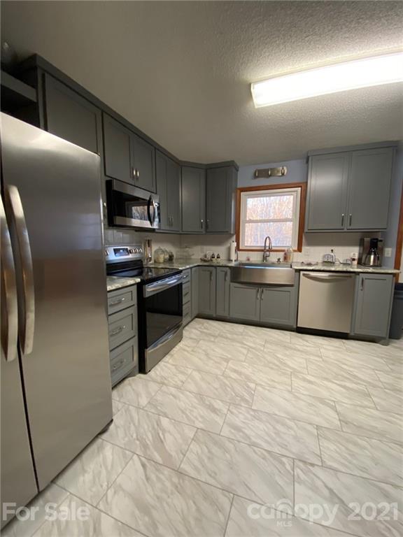 4903 Horseshoe Bend Road Hudson, NC 28638 - Photo 9 of 26 a large kitchen with cabinets and stainless steel appliances