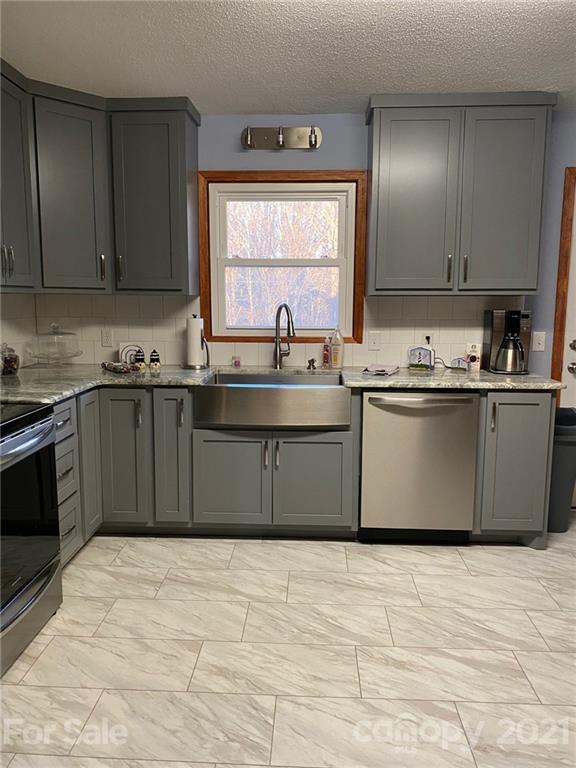 4903 Horseshoe Bend Road Hudson, NC 28638 - Photo 10 of 26 a kitchen with a sink cabinets and window
