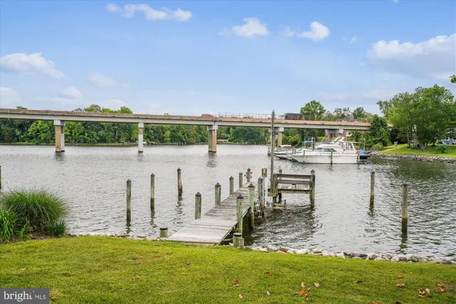 a view of a lake with a yard and outdoor seating