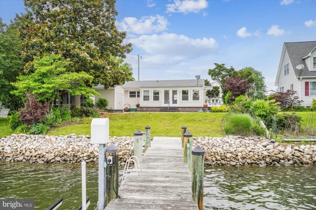 a view of a house with garden and lake view