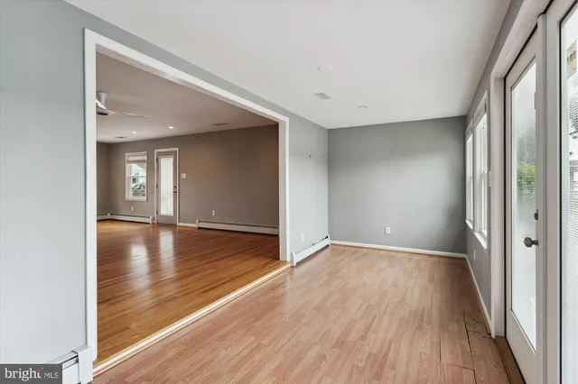 wooden floor in an empty room with a window