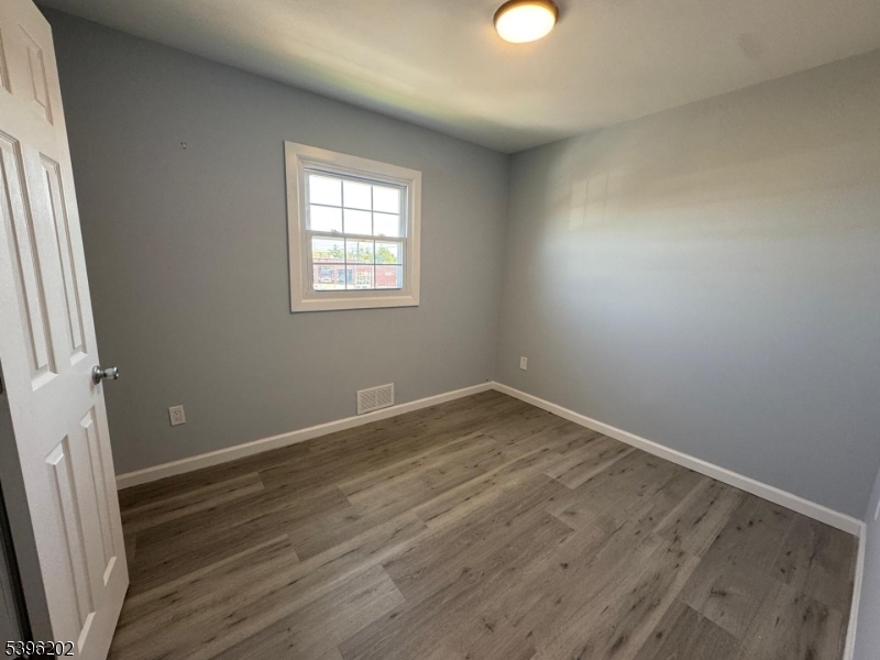 37 Irving Street Carteret, NJ 07008 - Photo 6 of 10 an empty room with wooden floor and windows