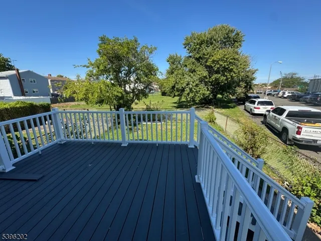 a view of a balcony with wooden floor
