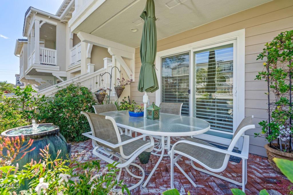 3729 Islander Walk Oxnard, CA 93035 - Photo 18 of 46 a view of a patio with table and chairs and potted plants