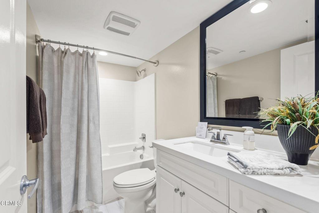 3729 Islander Walk Oxnard, CA 93035 - Photo 19 of 46 a bathroom with a granite countertop sink toilet and shower