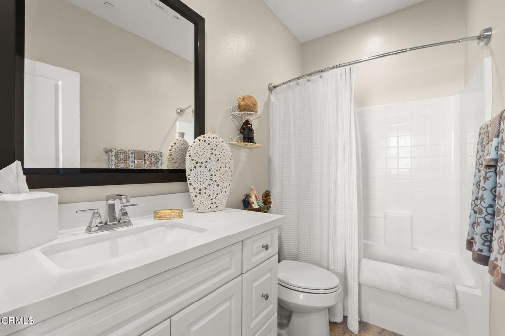 3729 Islander Walk Oxnard, CA 93035 - Photo 21 of 46 a bathroom with a sink toilet and shower