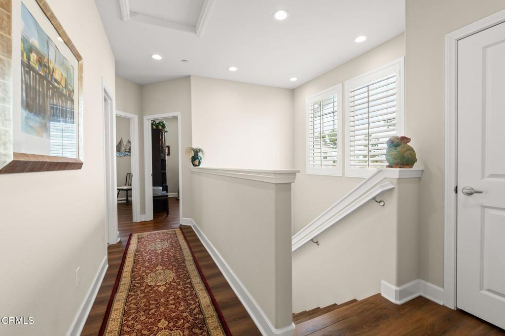 3729 Islander Walk Oxnard, CA 93035 - Photo 26 of 46 a hallway with windows and wooden floor