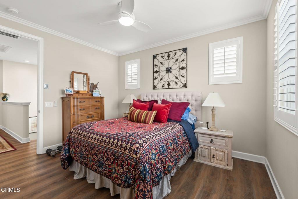3729 Islander Walk Oxnard, CA 93035 - Photo 29 of 46 a bedroom with a bed a dresser and wooden floor