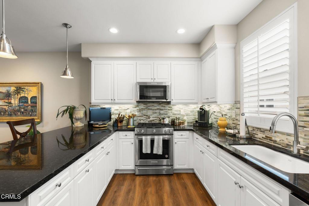 3729 Islander Walk Oxnard, CA 93035 - Photo 3 of 46 a kitchen with a stove a sink and a microwave