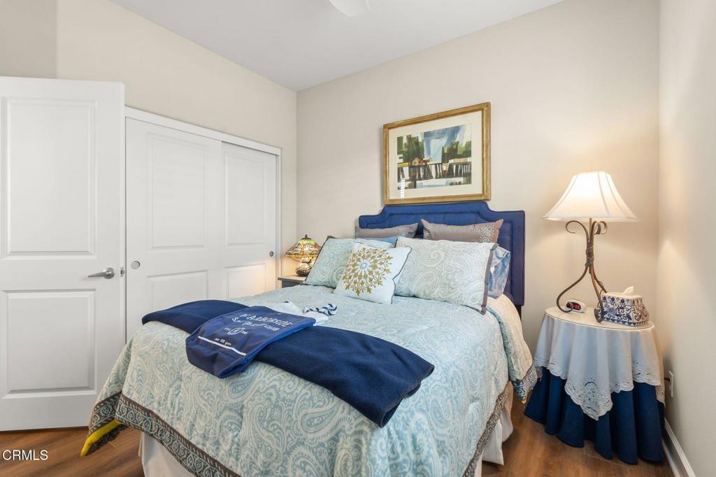 3729 Islander Walk Oxnard, CA 93035 - Photo 32 of 46 a bedroom with a bed and a lamp on the dresser