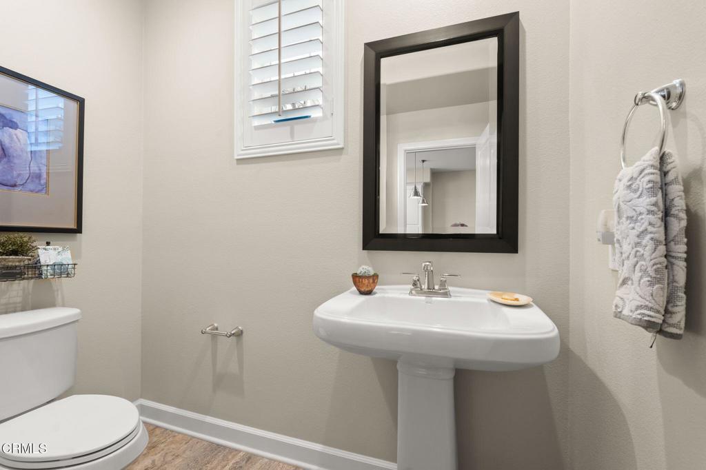 3729 Islander Walk Oxnard, CA 93035 - Photo 36 of 46 a bathroom with a toilet sink and mirror