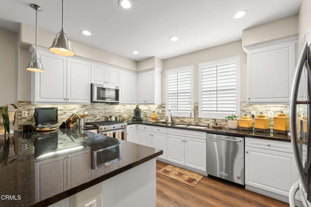 3729 Islander Walk Oxnard, CA 93035 - Photo 5 of 46 a kitchen with lots of counter top space a sink and appliances