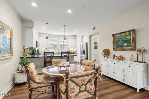 a view of a dining room with furniture and wooden floor