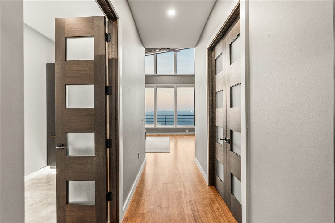 2623 Alum Cave Road Bee Branch, AR 72013 - Photo 24 of 60 Hardwood flooring extending through a hallway with modern interior doors featuring frosted glass panels